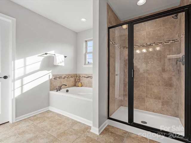 full bath featuring baseboards, a shower stall, a bath, and tile patterned floors