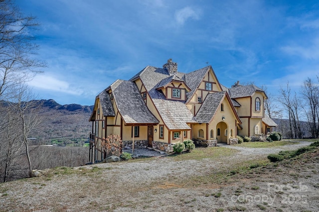 view of front of property featuring a chimney and stucco siding