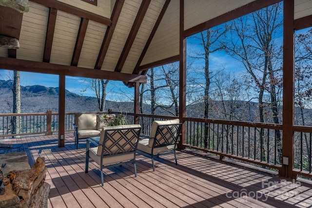 wooden terrace with an outdoor hangout area and a mountain view