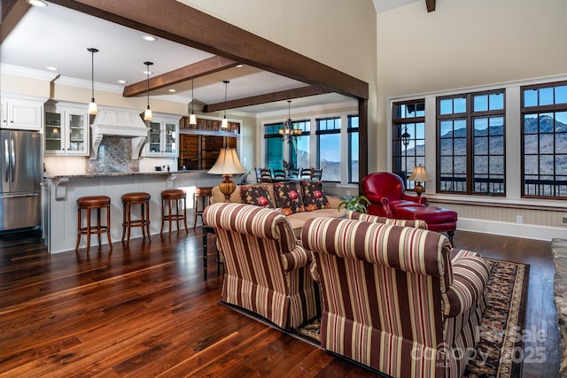 living room featuring recessed lighting, dark wood-type flooring, ornamental molding, beamed ceiling, and an inviting chandelier