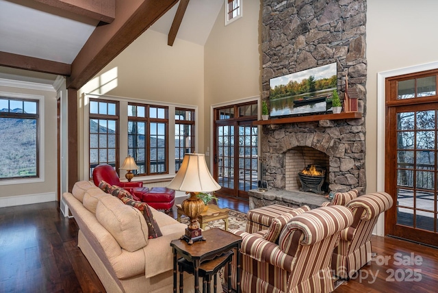 living room featuring beam ceiling, a fireplace, wood finished floors, high vaulted ceiling, and baseboards