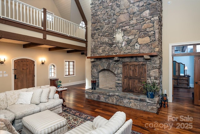 living room featuring a fireplace, wood finished floors, high vaulted ceiling, beamed ceiling, and baseboards