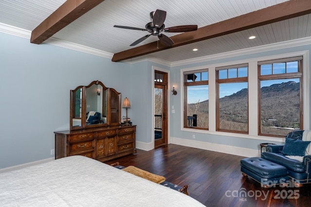 bedroom featuring beam ceiling, a mountain view, and baseboards