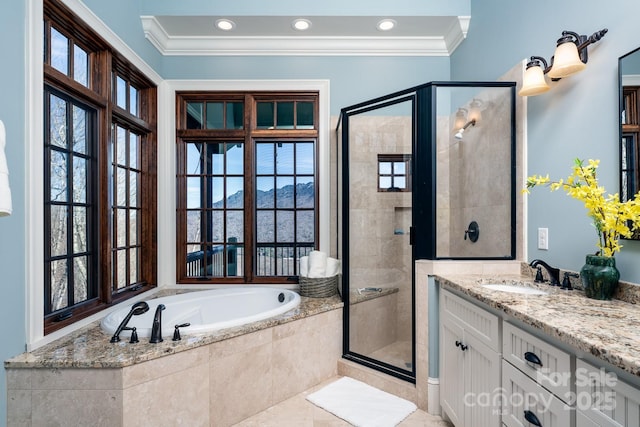 full bathroom featuring a garden tub, ornamental molding, a shower stall, and vanity