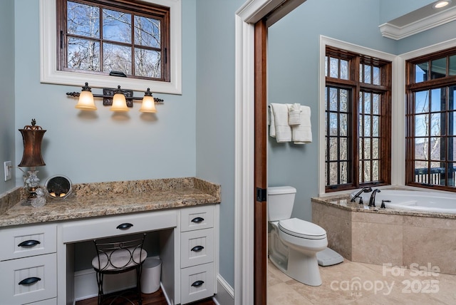 bathroom featuring plenty of natural light, a garden tub, toilet, and crown molding