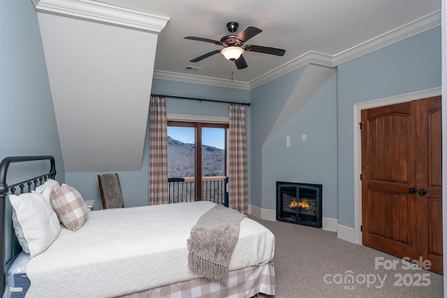 carpeted bedroom featuring crown molding, visible vents, a glass covered fireplace, access to outside, and baseboards