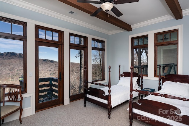 bedroom featuring visible vents, multiple windows, beamed ceiling, and a mountain view