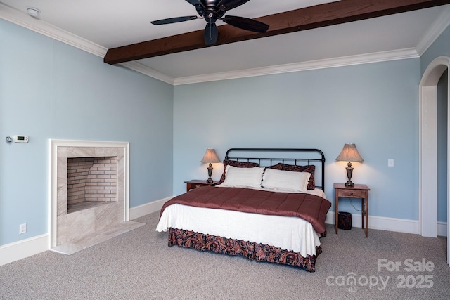 bedroom featuring arched walkways, carpet floors, ornamental molding, and beam ceiling