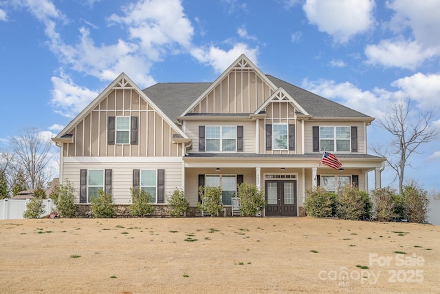 craftsman inspired home featuring french doors, board and batten siding, and fence