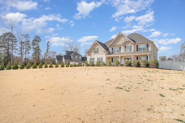 craftsman inspired home featuring a gate, board and batten siding, and fence