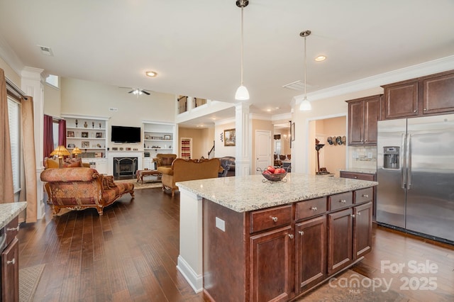 kitchen featuring visible vents, decorative columns, a fireplace, stainless steel fridge with ice dispenser, and dark wood-style flooring