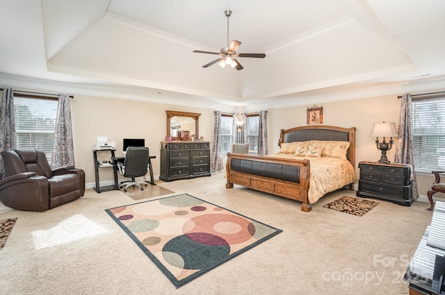 carpeted bedroom featuring a raised ceiling, baseboards, and ornamental molding