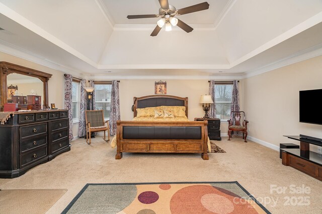 bedroom with a tray ceiling, carpet, and ornamental molding