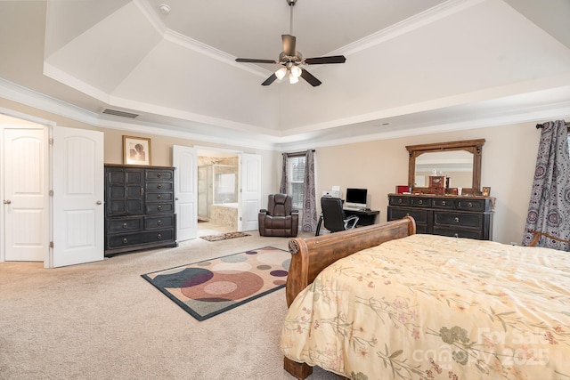 carpeted bedroom featuring visible vents, ensuite bathroom, crown molding, and a tray ceiling