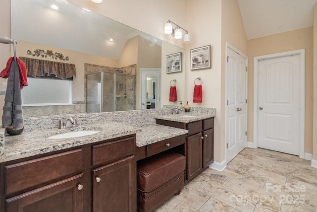 full bathroom with vanity, lofted ceiling, baseboards, and a shower stall