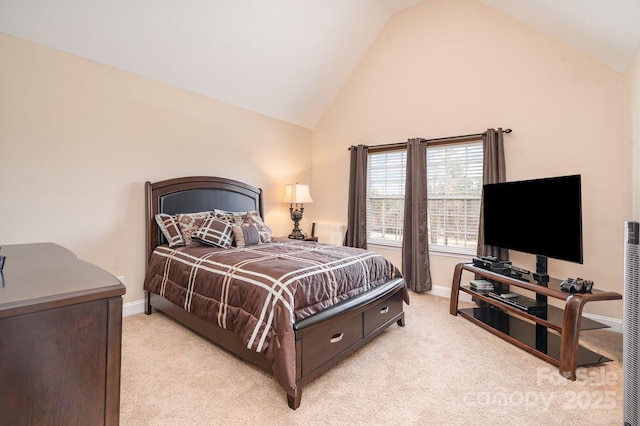 bedroom with light colored carpet, baseboards, and high vaulted ceiling