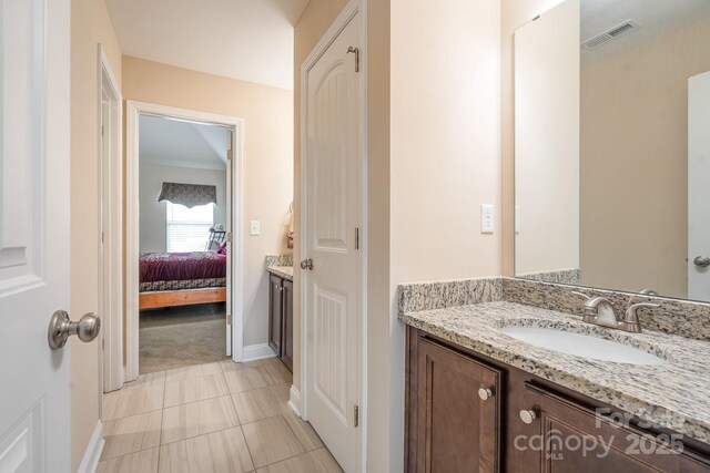 ensuite bathroom with visible vents, baseboards, connected bathroom, and vanity