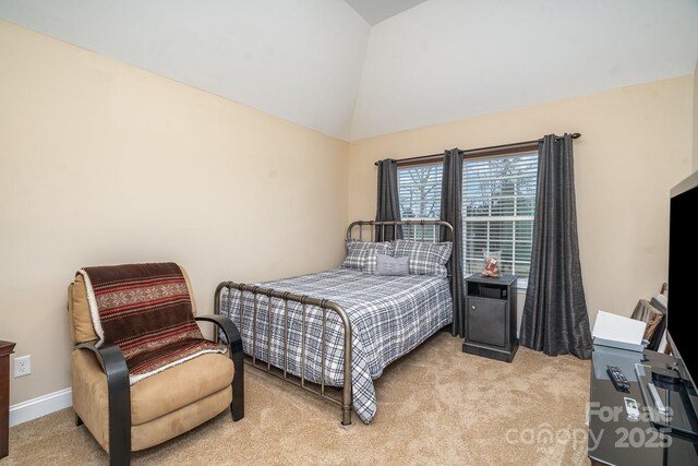 bedroom featuring baseboards, light carpet, and lofted ceiling