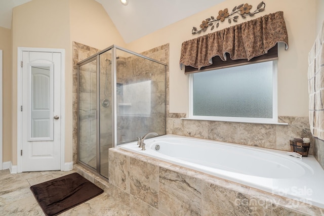 bathroom with vaulted ceiling, a bath, and a stall shower