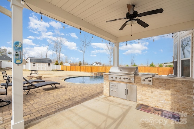 view of patio / terrace featuring an outdoor kitchen, a fenced backyard, ceiling fan, an outdoor structure, and grilling area