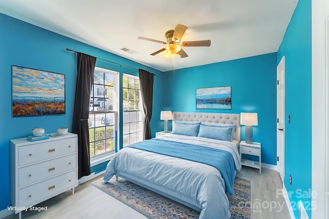 bedroom with visible vents, ceiling fan, light wood-style flooring, and baseboards