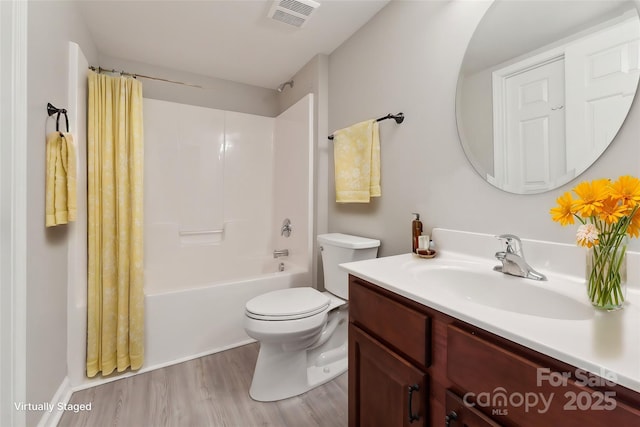 full bathroom featuring shower / bath combo, visible vents, toilet, wood finished floors, and vanity