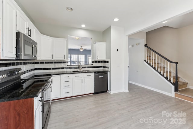 kitchen featuring dishwashing machine, a sink, stainless steel electric range, tasteful backsplash, and dark countertops