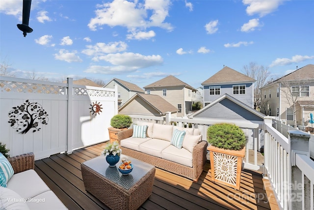 deck featuring an outdoor hangout area and a residential view