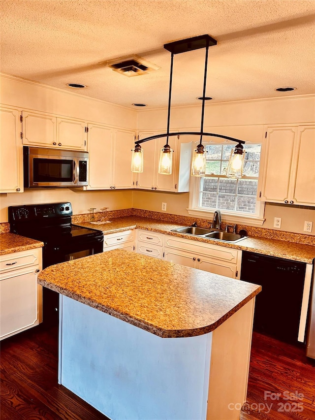 kitchen featuring dark wood-style floors, black appliances, a sink, and white cabinets