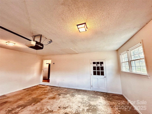 garage featuring baseboards and a garage door opener