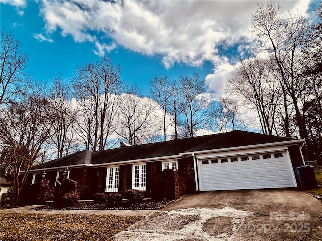 view of front of property with aphalt driveway and an attached garage