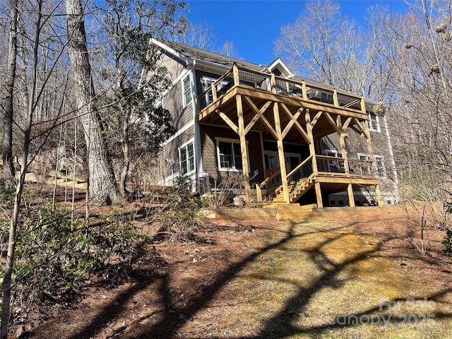 back of house with a deck and stairs