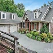 cape cod home with a garage and concrete driveway