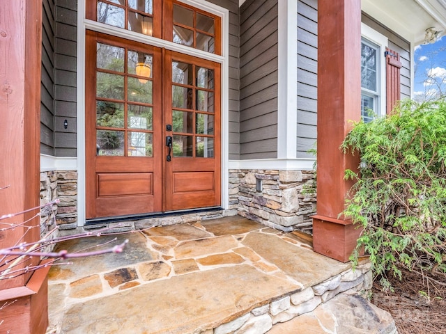 entrance to property with french doors and stone siding