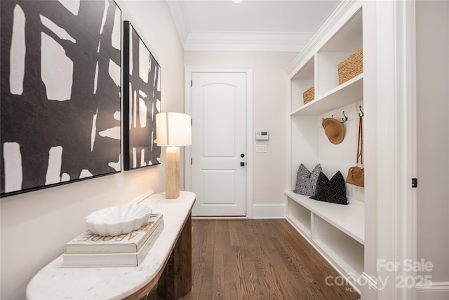 mudroom featuring crown molding, baseboards, and dark wood-style flooring