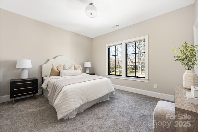 bedroom featuring visible vents, baseboards, and carpet