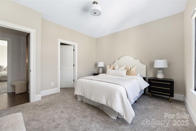 carpeted bedroom featuring baseboards