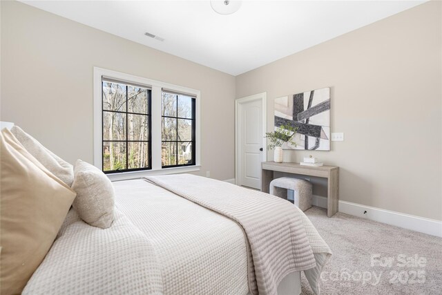 carpeted bedroom with visible vents and baseboards