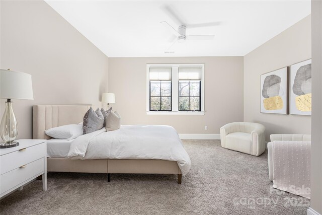 carpeted bedroom with a ceiling fan and baseboards