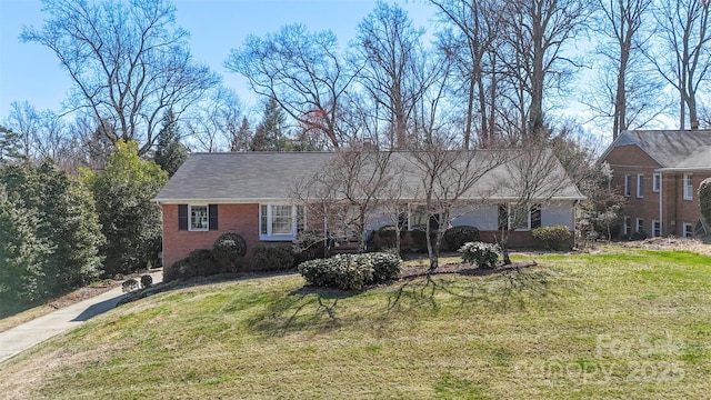 single story home with a front lawn and brick siding