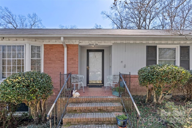 property entrance with brick siding