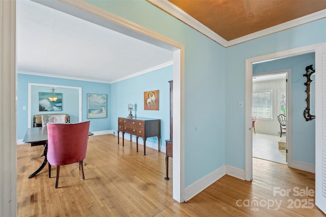 dining area with wood finished floors, baseboards, and ornamental molding