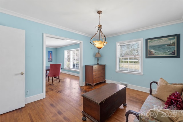 interior space with visible vents, ornamental molding, baseboards, and wood finished floors