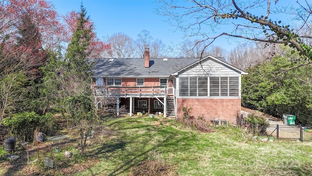 rear view of property with stairway, fence, a deck, a lawn, and brick siding