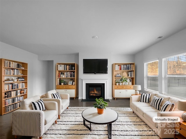 living room featuring a fireplace with flush hearth