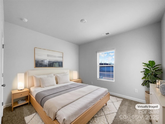 bedroom featuring carpet floors, visible vents, and baseboards