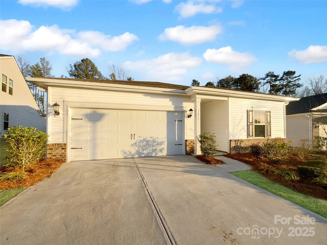 view of front of home featuring a garage, concrete driveway, and brick siding