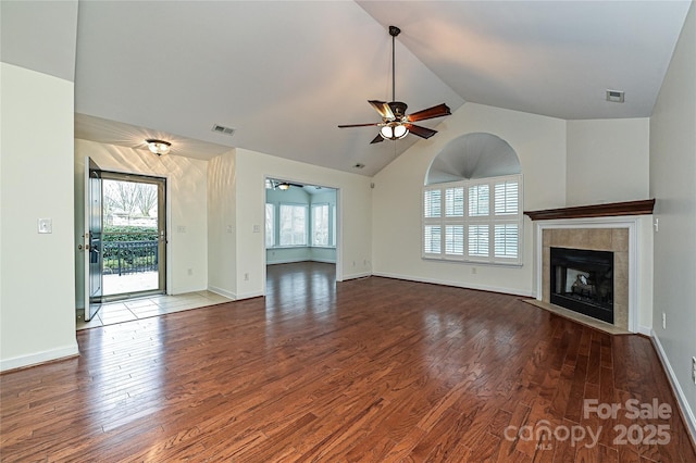 unfurnished living room with a wealth of natural light, a fireplace, and visible vents