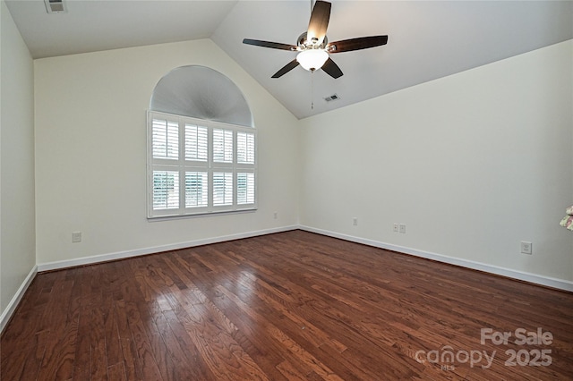 unfurnished room featuring lofted ceiling, dark wood-style flooring, visible vents, a ceiling fan, and baseboards