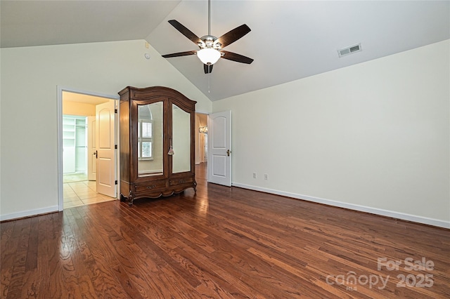 empty room with high vaulted ceiling, wood finished floors, visible vents, baseboards, and a ceiling fan